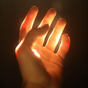 persons hand on black background